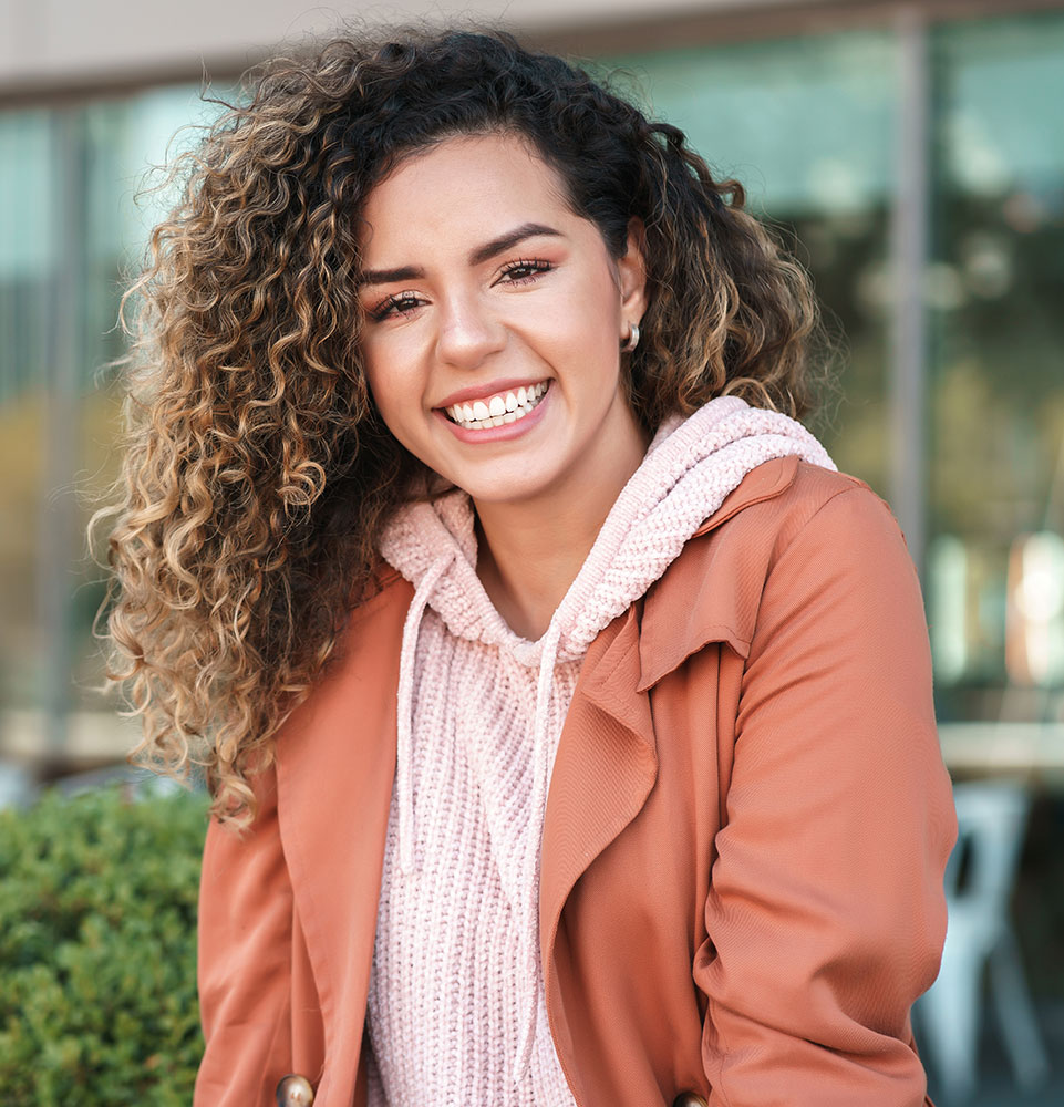 Woman on street in orange jacket